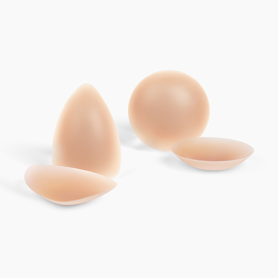 A set of different shapes and sizes of silicone breast enhancers.